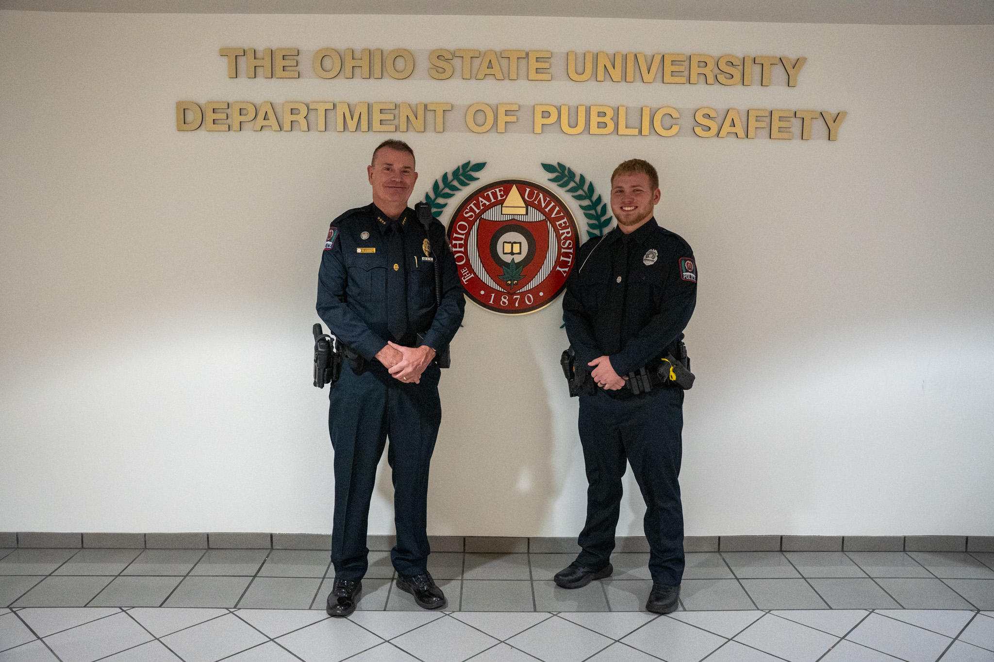 The Police Chief standing next to a new officer.