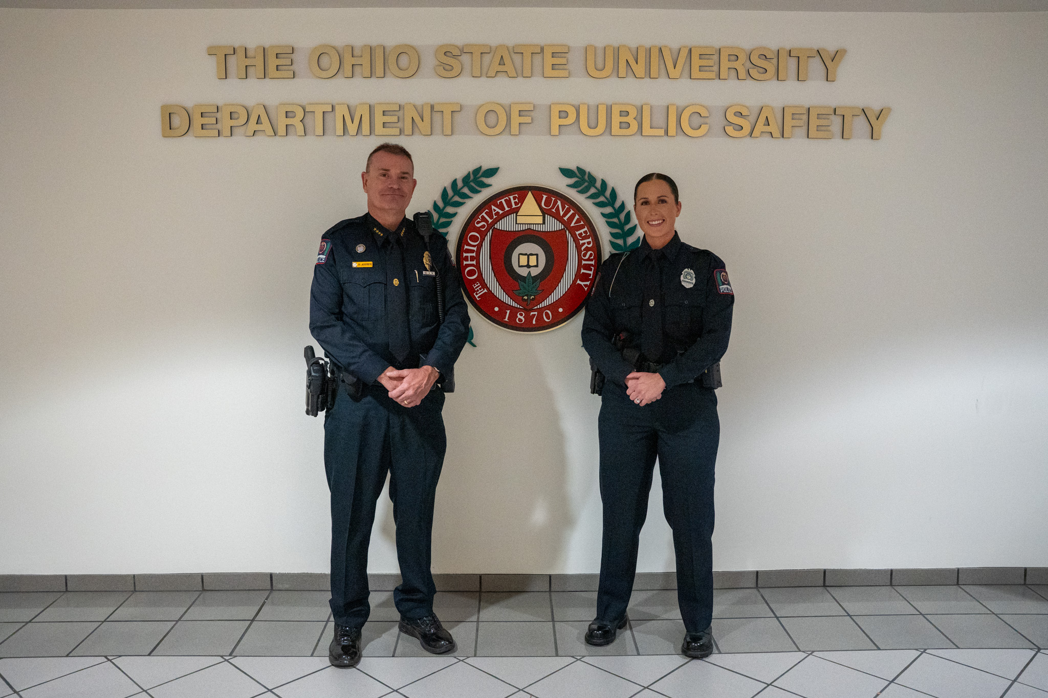 The Police Chief standing next to a new officer.