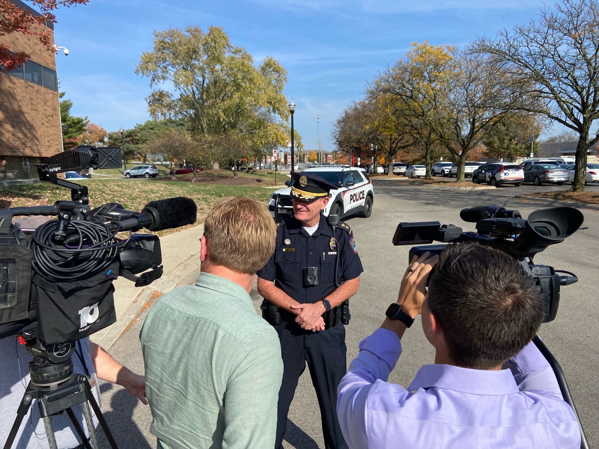 Dennis Jeffrey being interviewed by local media holding two cameras.