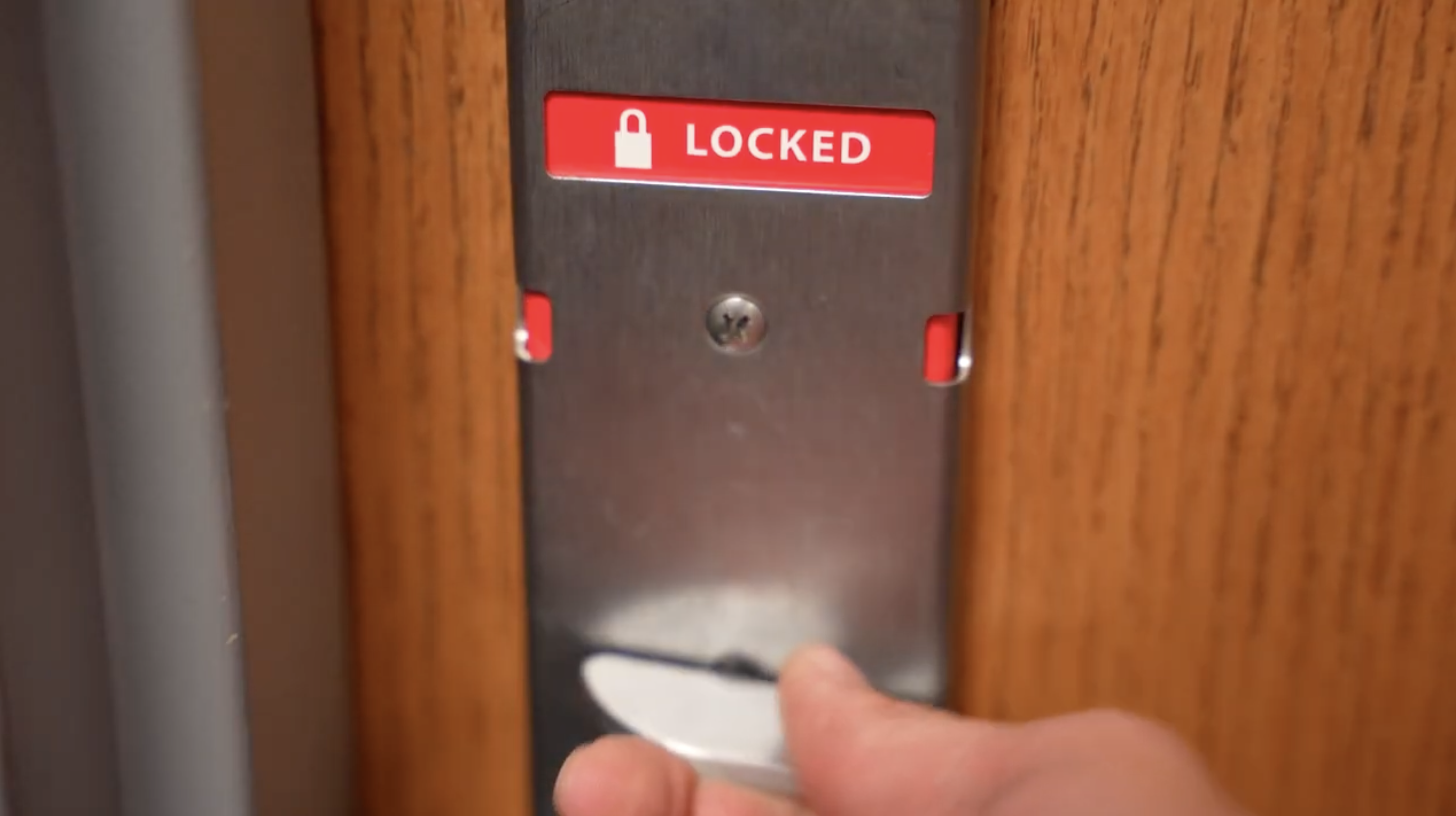 A door lock that is red and says, 'LOCKED'