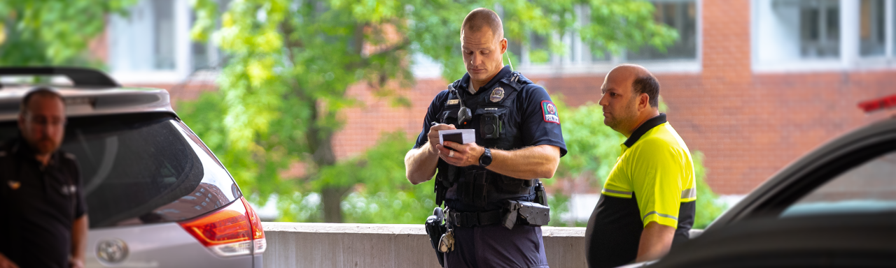 Image of an OSUPD officer taking notes at the scene of an accident