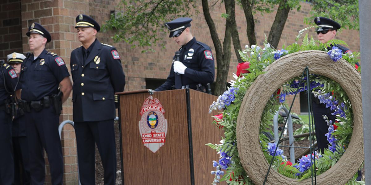 officers at a memorial ceremony in front of Blankenship Hall