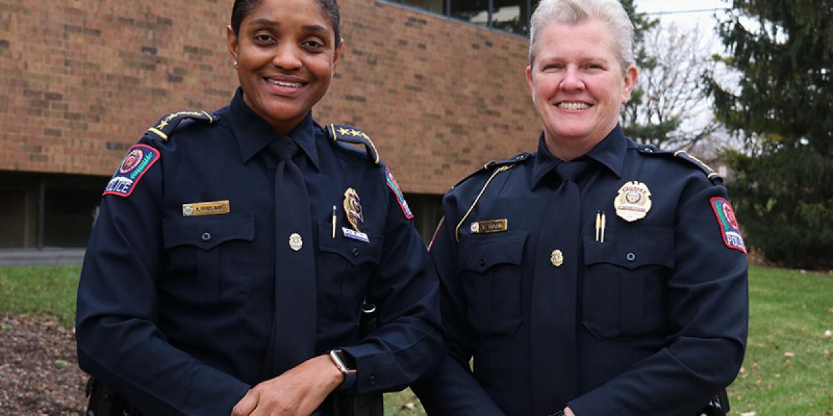 the chief and deputy chief standing in front of Blankenship Hall