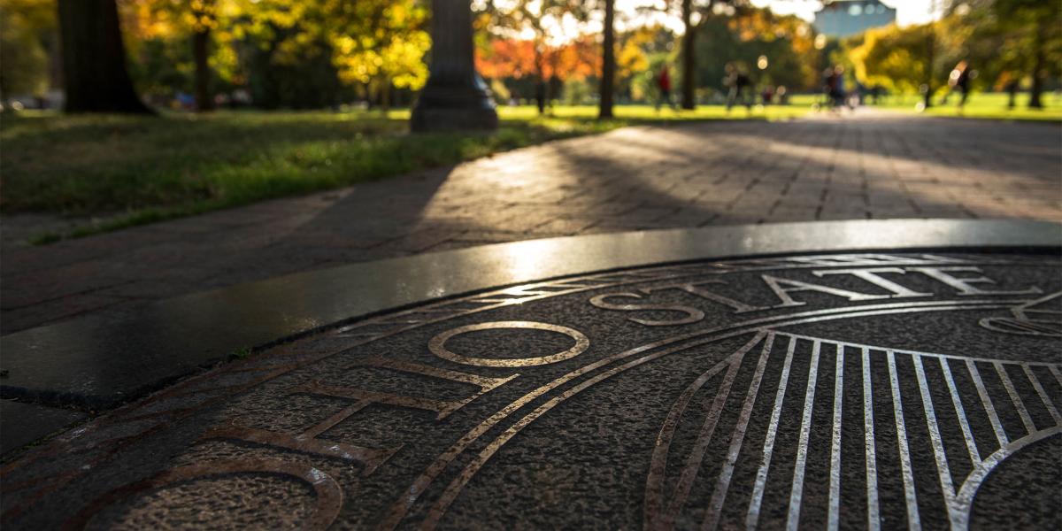 university seal on the Oval sidewalk