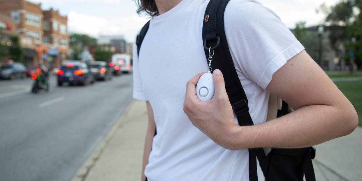 photo of person with personal safety device on bookbag