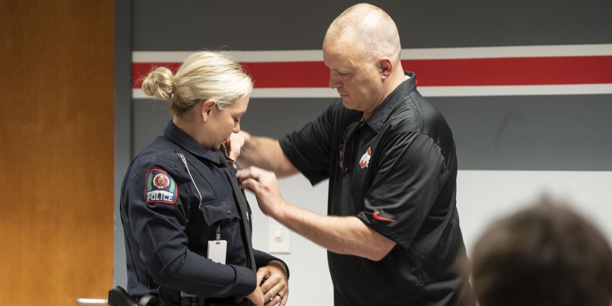 Officer Kovach being receiving her pin. 