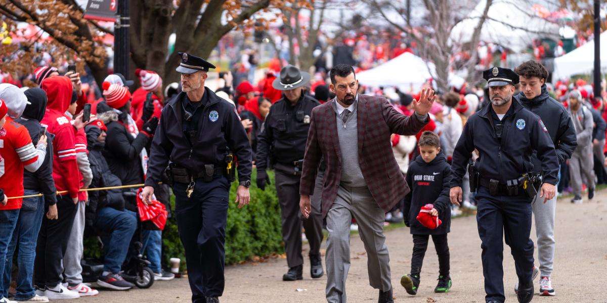 Officers escort Coach Day.