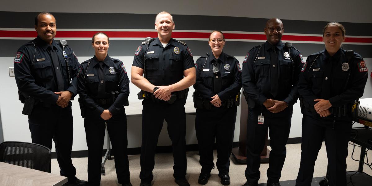 Five new officers standing with Deputy Chief Eric Whiteside.