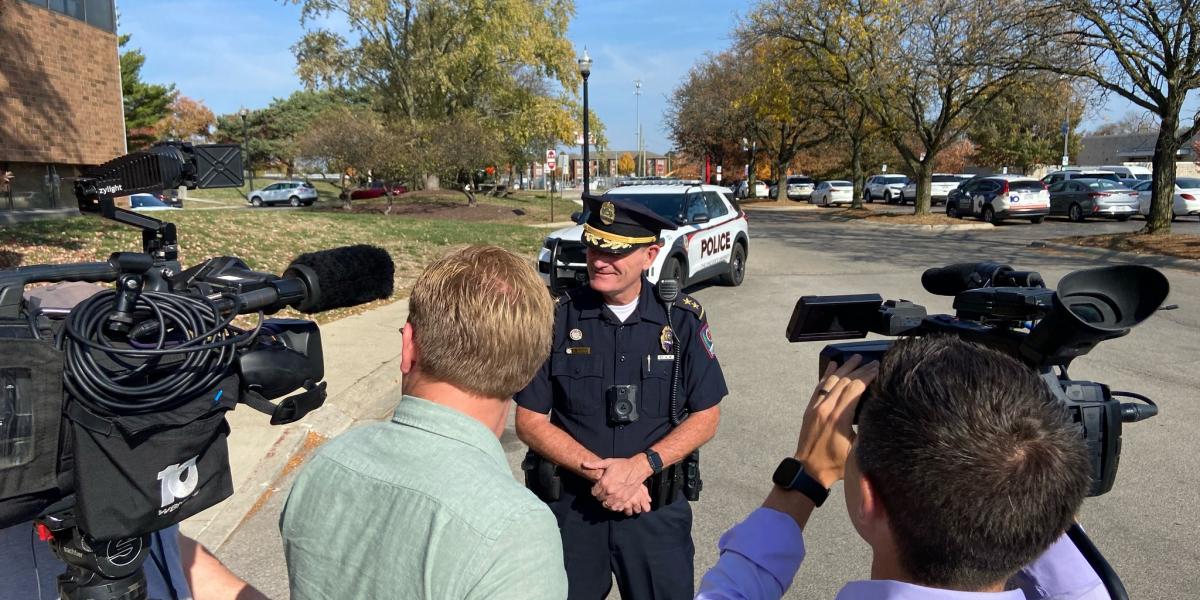 Dennis Jeffrey being interviewed by local media holding two cameras.