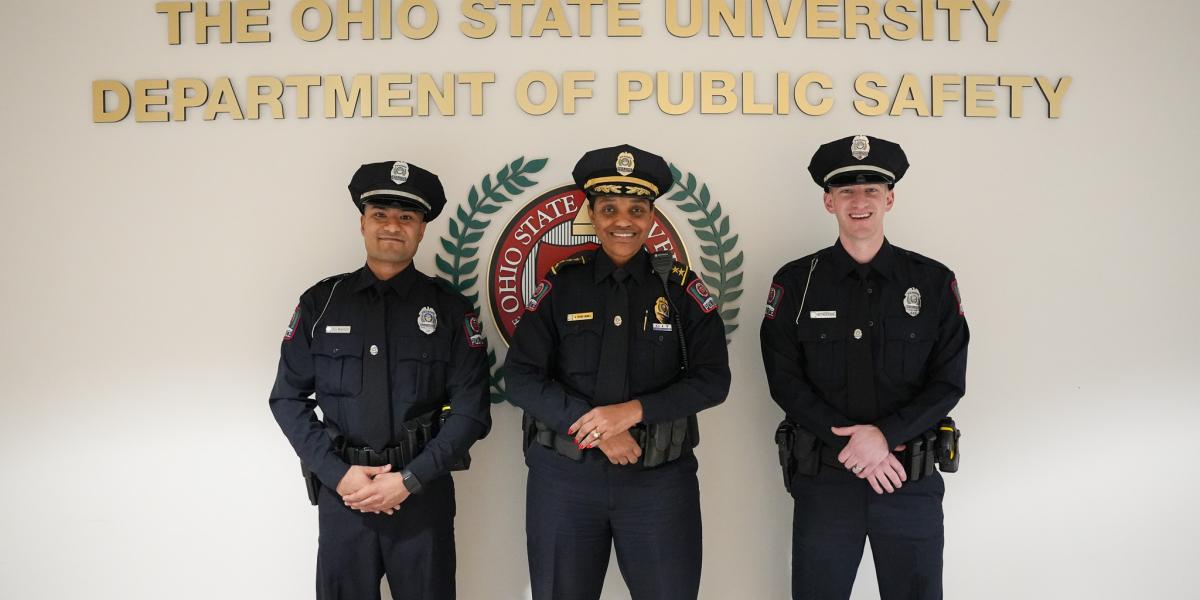 New OSUPD Officers Rahut and Krasa smile for a photo with Chief Spears-McNatt