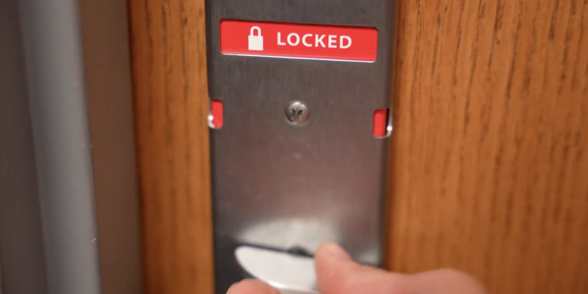 A door lock that is red and says, 'LOCKED'