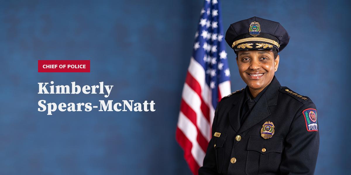 chief kimberly spears-mcnatt next to american flag