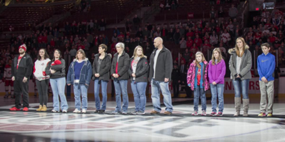 family of Michael Blankenship stand on ice rink