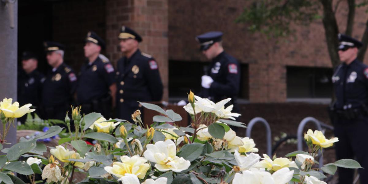 police officers standing near flowers