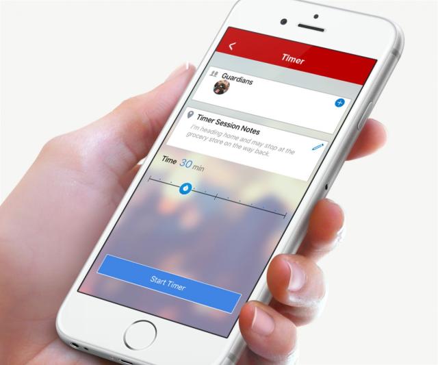 hand holding a cell phone with the guardian app on the display