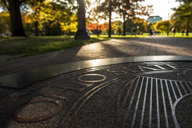 university seal on the Oval sidewalk
