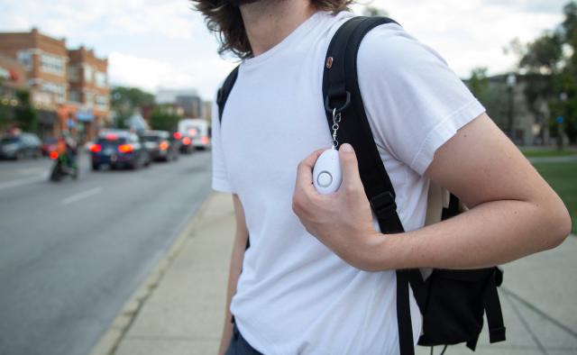 photo of person with personal safety device on bookbag