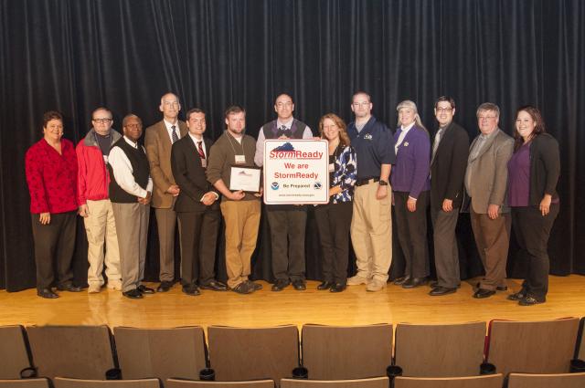 group of people holdin storm ready certificate