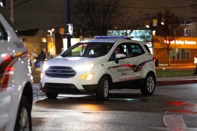 Campus security vehicle with lights on, parked at the Ohio Union