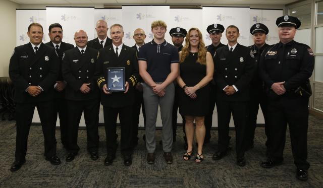 Officers standing with 16-year-old Ethan McKendry