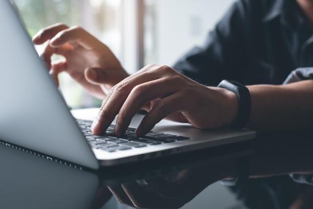 hands typing on laptop