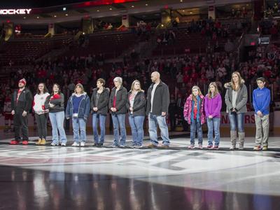family of Michael Blankenship stand on ice rink