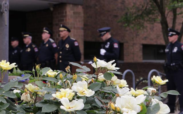 police officers standing near flowers
