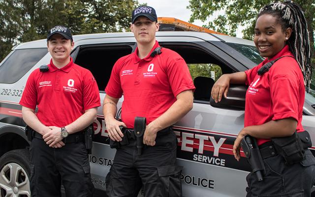 3 staff members wearing Student Safety Service shirts