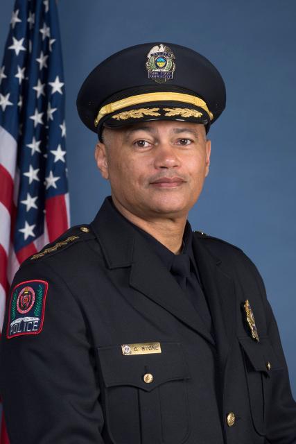 Headshot of OSU Police Chief Craig Stone next to American flag