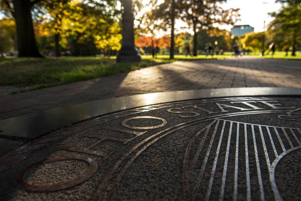 university seal on the Oval sidewalk