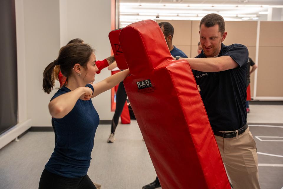 A woman is shown hitting a mat