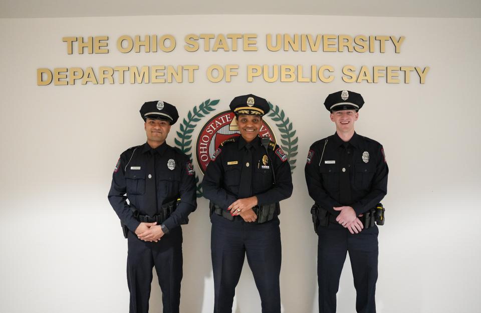 New OSUPD Officers Rahut and Krasa smile for a photo with Chief Spears-McNatt