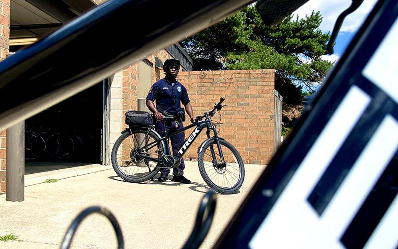 Officer standing next to a bicycle
