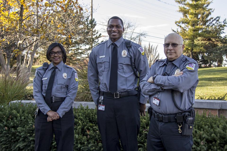 Three Central Campus Security Services members in new grey uniforms