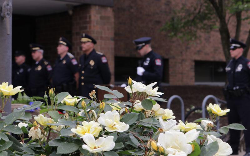 police officers standing near flowers