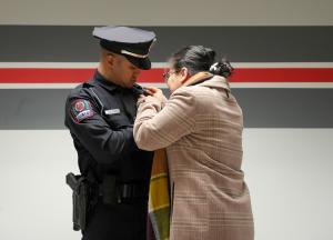 Officer Nobin Rahut being 'pinned' by a loved one.